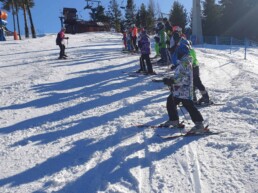 Dzieci i młodzież podczas nauki na obozie narciarskim